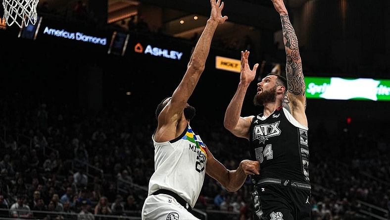 April 8, 2023; Austin, TX, USA; San Antonio Spurs forward Sandro Mamukelashvili (54) shoots over Minnesota Timberwolves center Rudy Gobert (27) during the game at the Moody Center on Saturday, April 8, 2023 in Austin. Mandatory Credit: Aaron E. Martinez-USA TODAY NETWORK