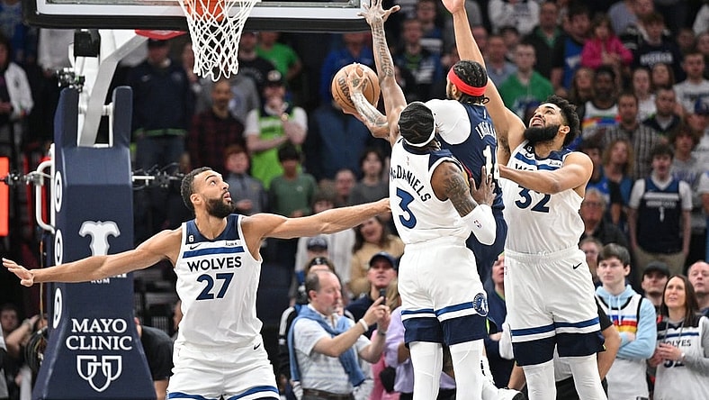 Apr 9, 2023; Minneapolis, Minnesota, USA; New Orleans Pelicans forward Brandon Ingram (14) goes to the basket as Minnesota Timberwolves center Karl-Anthony Towns (32), forward Jaden McDaniels (3) and center Rudy Gobert (27) defend during the first quarter at Target Center. Mandatory Credit: Jeffrey Becker-USA TODAY Sports