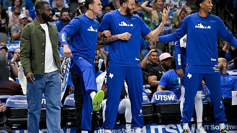 Apr 9, 2023; Dallas, Texas, USA; Dallas Mavericks forward Tim Hardaway Jr. (11) and center Dwight Powell (7) and center JaVale McGee (00) and forward Christian Wood (35) celebrate on the team bench during the second quarter against the San Antonio Spurs at the American Airlines Center. Mandatory Credit: Jerome Miron-USA TODAY Sports
