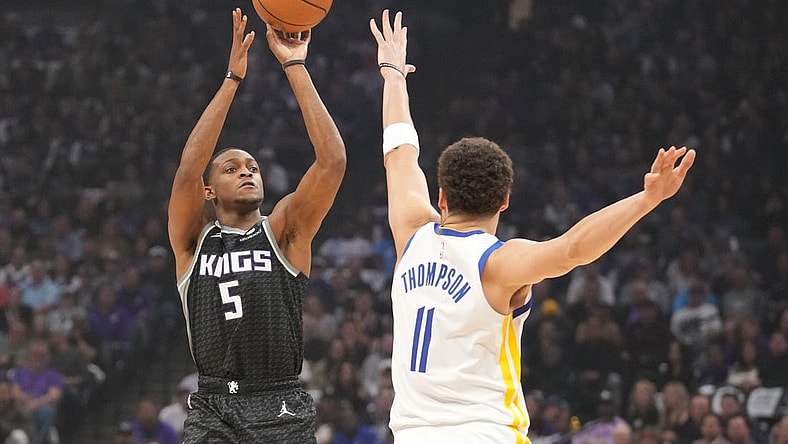 April 17, 2023; Sacramento, California, USA; Sacramento Kings guard De'Aaron Fox (5) shoots the basketball against Golden State Warriors guard Klay Thompson (11) during the first quarter in game two of the first round of the 2023 NBA playoffs at Golden 1 Center. Mandatory Credit: Kyle Terada-USA TODAY Sports