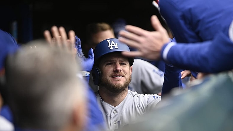 Apr 22, 2023; Chicago, Illinois, USA;Los Angeles Dodgers third baseman Max Muncy (13) celebrates in the dugout after hitting a two run home run against the Chicago Cubs during the ninth inning at Wrigley Field. Mandatory Credit: Matt Marton-USA TODAY Sports