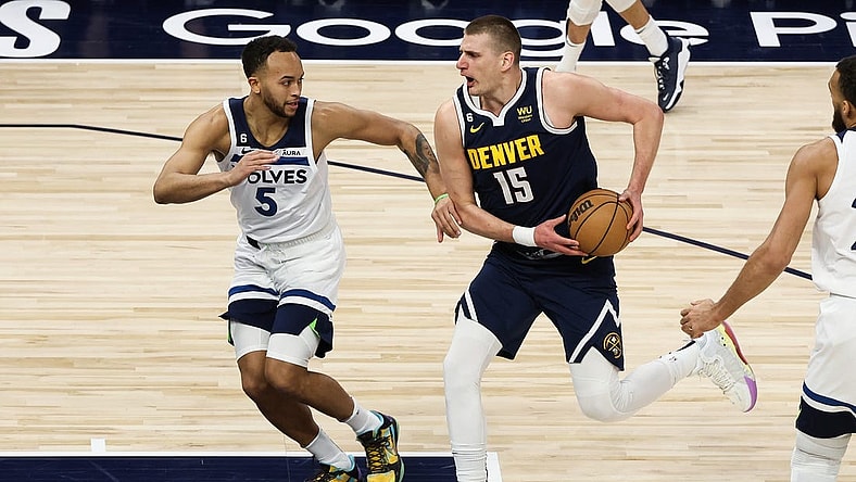 Apr 23, 2023; Minneapolis, Minnesota, USA; Denver Nuggets center Nikola Jokic (15) drives to the basket while Minnesota Timberwolves forward Kyle Anderson (5) defends during the first quarter of game four of the 2023 NBA Playoffs at Target Center. Mandatory Credit: Matt Krohn-USA TODAY Sports