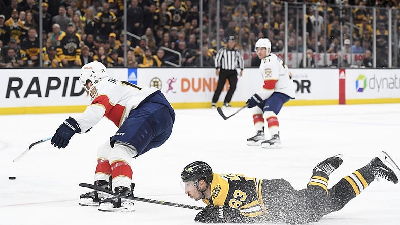 Apr 30, 2023; Boston, Massachusetts, USA; Boston Bruins left wing Brad Marchand (63) gets tripped up while Florida Panthers left wing Matthew Tkachuk (19) skates after the loose puck during the first period in game seven of the first round of the 2023 Stanley Cup Playoffs at TD Garden. Mandatory Credit: Bob DeChiara-USA TODAY Sports