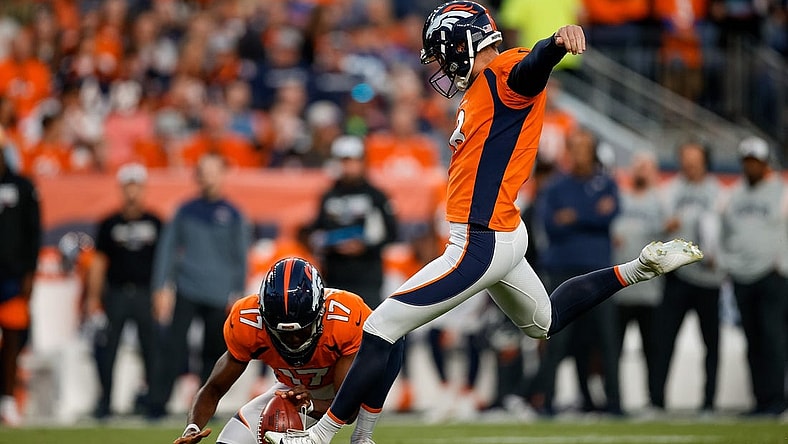 Oct 6, 2022; Denver, Colorado, USA; Denver Broncos place kicker Brandon McManus (8) kicks a field goal on a hold from punter Corliss Waitman (17) in the first quarter against the Indianapolis Colts at Empower Field at Mile High. Mandatory Credit: Isaiah J. Downing-USA TODAY Sports