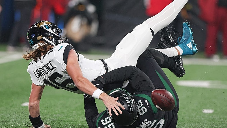Dec 22, 2022; East Rutherford, New Jersey, USA; Jacksonville Jaguars quarterback Trevor Lawrence (16) is sacked by New York Jets defensive tackle Quinnen Williams (95) during the first half at MetLife Stadium. Mandatory Credit: Vincent Carchietta-USA TODAY Sports