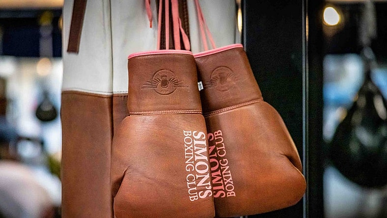 A pair of boxing gloves hang inside Simon  s Boxing Club January 23, 2023. Simon "The Phoenix" Bakinde was born in Cameroon, Central Africa and grew up in a small impoverished village named Omeng.
