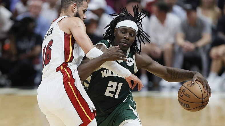 Apr 22, 2023; Miami, Florida, USA; Milwaukee Bucks guard Jrue Holiday (21) drives to the basket against Miami Heat forward Caleb Martin (16) in the third quarter during game three of the 2023 NBA Playoffs at Kaseya Center. Mandatory Credit: Sam Navarro-USA TODAY Sports