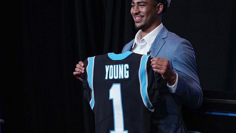 Apr 28, 2023; Charlotte, NC, USA; Bryce Young holds up a jersey depicting his draft position at Bank of America Stadium. Mandatory Credit: Jim Dedmon-USA TODAY Sports