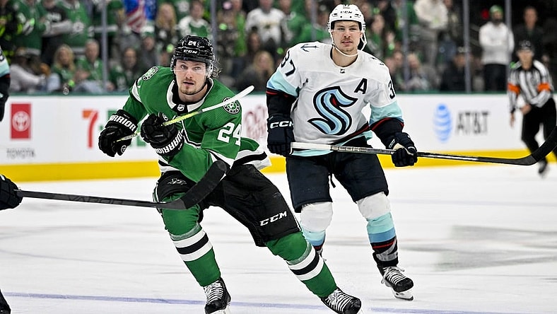 May 2, 2023; Dallas, Texas, USA; Dallas Stars center Roope Hintz (24) and Seattle Kraken center Yanni Gourde (37) chase the puck during the overtime period in game one of the second round of the 2023 Stanley Cup Playoffs at the American Airlines Center. Mandatory Credit: Jerome Miron-USA TODAY Sports