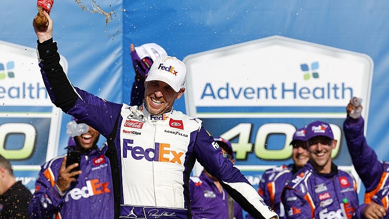 May 7, 2023; Kansas City, Kansas, USA; NASCAR Cup Series driver Denny Hamlin (11) reacts after winning the AdventHealth 400 at Kansas Speedway. Mandatory Credit: Mike Dinovo-USA TODAY Sports