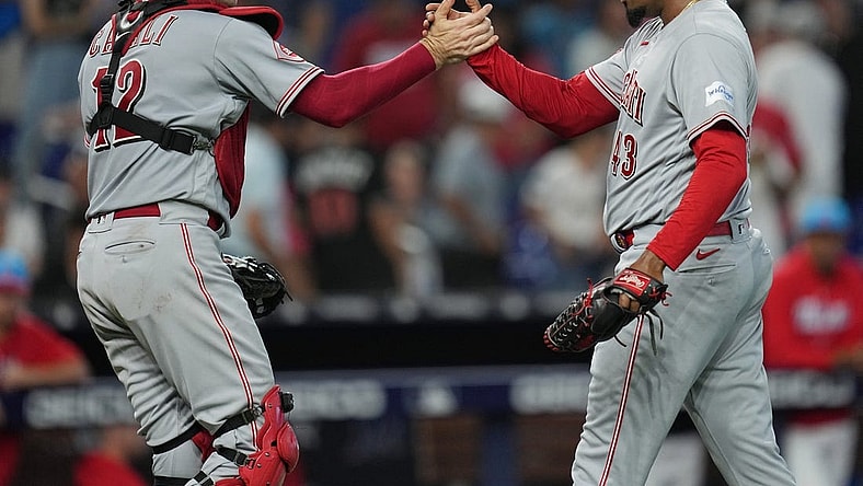 May 13, 2023; Miami, Florida, USA; Cincinnati Reds relief pitcher Alexis Diaz (43) and catcher Curt Casali (12) celebrate a victory over the Miami Marlins at loanDepot Park. Mandatory Credit: Jim Rassol-USA TODAY Sports