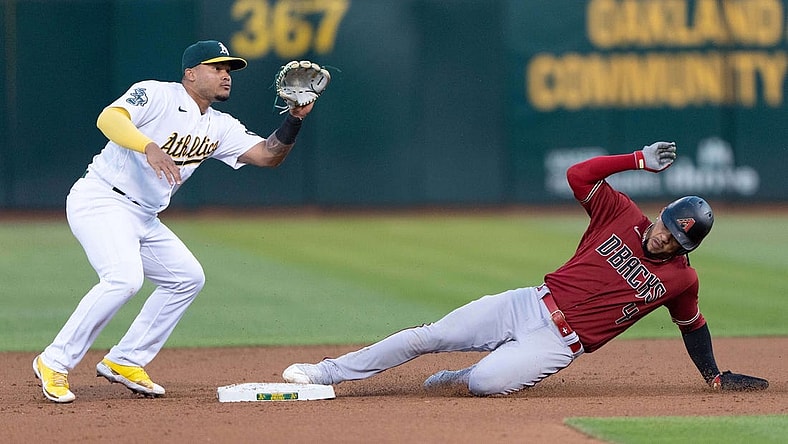 May 16, 2023; Oakland, California, USA; Arizona Diamondbacks second baseman Ketel Marte (4) slides into second base during the fifth inning against Oakland Athletics second baseman Jordan Diaz (13) at Oakland-Alameda County Coliseum. Mandatory Credit: Stan Szeto-USA TODAY Sports