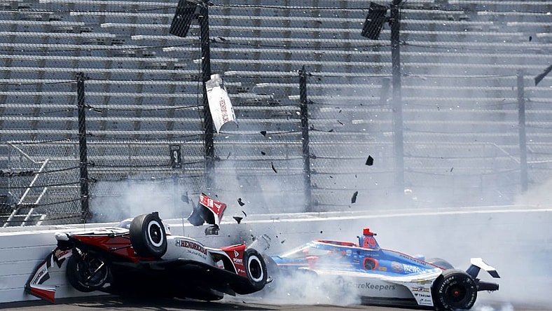 May 22, 2023; Speedway, Indiana, USA;Rahal Letterman Lanigan Racing driver Katherine Legge (44) and Dreyer & Reinbold Racing driver Stefan Wilson (24) crash in the first turn Monday, May 22, 2023, during practice ahead of the 107th running of the Indianapolis 500 at Indianapolis Motor Speedway. Mandatory Credit: John Chilton-USA TODAY Sports