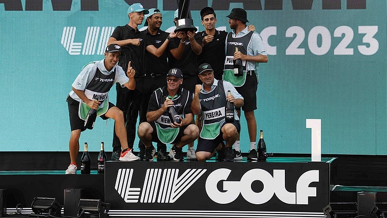 May 28, 2023; Potomac Falls, Virginia, USA; Members of Team Torque celebrate on the podium after winning the team championship of LIV Golf Washington, D.C. golf tournament at Trump National. Mandatory Credit: Geoff Burke-USA TODAY Sports