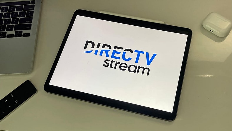 DIRECTV STREAM logo on an iPad sitting on a desk