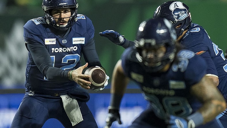 Nov 20, 2022; Regina, Saskatchewan, CAN; Toronto Argonauts quarterback Chad Kelly (12) hands the ball off to running back Andrew Harris (33) against the Winnipeg Blue Bombers in the second half. The Argonauts defeated the Blue Bombers to win the 2022 Grey Cup Championship at Mosaic Stadium. Toronto won 24-23. Mandatory Credit: Bob Frid-USA TODAY Sports