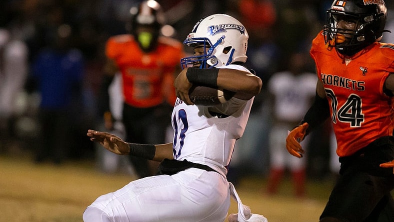 Pahokee quarterback Austin Simmons (13) slides into a first down during first half action on  Friday, Nov. 25, 2022, at Hawthorne High School in Hawthorne, Fla. during the 2022 FHSAA Football State Championships play off.  Hawthorne held on to win 21-20.  [Alan Youngblood/Gainesville Sun]

Flgai 112722 Pahokee Hawthorne 03583060