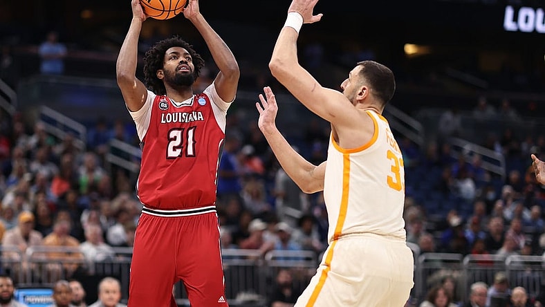 Mar 16, 2023; Orlando, FL, USA; Louisiana Ragin Cajuns forward Jordan Brown (21) shoots the ball over Tennessee Volunteers forward Uros Plavsic (33) during the first half at Amway Center. Mandatory Credit: Matt Pendleton-USA TODAY Sports
