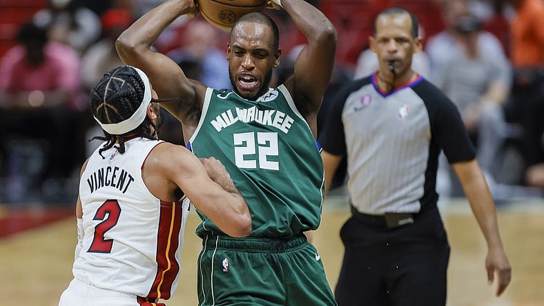 Apr 22, 2023; Miami, Florida, USA; Milwaukee Bucks forward Khris Middleton (22) protects the basketball from Miami Heat guard Gabe Vincent (2) in the third quarter during game three of the 2023 NBA Playoffs at Kaseya Center. Mandatory Credit: Sam Navarro-USA TODAY Sports