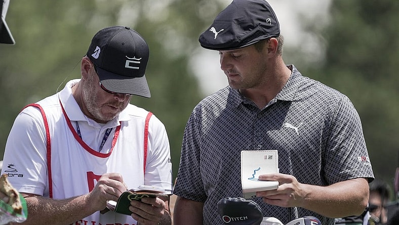 May 6, 2021; Charlotte, North Carolina, USA;  Bryson DeChambeau talks with his caddie Tim Tucker during the first round of the Wells Fargo Championship golf tournament. Mandatory Credit: Jim Dedmon-USA TODAY Sports