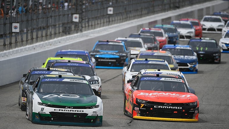 Jul 16, 2022; Loudon, New Hampshire, USA; NASCAR Xfinity Series driver Daniel Hemric (11) and driver Justin Allgaier (7) race during the Crayon 200 at New Hampshire Motor Speedway. Mandatory Credit: Eric Canha-USA TODAY Sports