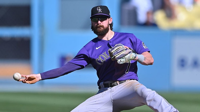 Oct 2, 2022; Los Angeles, California, USA; Colorado Rockies second baseman Brendan Rodgers (7) makes a play to throw out Los Angeles Dodgers first baseman Freddie Freeman (5) at second base in the sixth inning at Dodger Stadium. Mandatory Credit: Jayne Kamin-Oncea-USA TODAY Sports