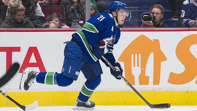 Nov 29, 2022; Vancouver, British Columbia, CAN; Vancouver Canucks forward Nils Hoglander (21) handles the puck  against the Washington Capitals in the third period at Rogers Arena. Washington won 5-1. Mandatory Credit: Bob Frid-USA TODAY Sports
