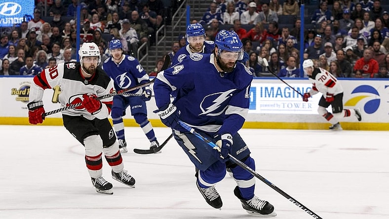 Mar 19, 2023; Tampa, Florida, USA; Tampa Bay Lightning left wing Pat Maroon (14) carries puck past New Jersey Devils left wing Tomas Tatar (90) during the second period at Amalie Arena. Mandatory Credit: Morgan Tencza-USA TODAY Sports