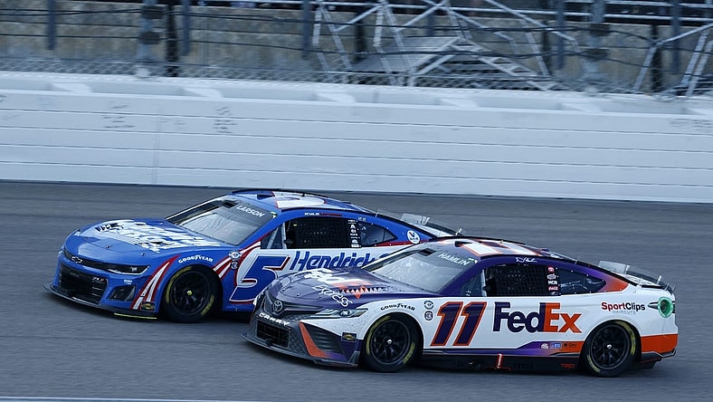 May 7, 2023; Kansas City, Kansas, USA; NASCAR Cup Series driver Denny Hamlin (11) attempts to take the lead from driver Kyle Larson (5) during the AdventHealth 400 at Kansas Speedway. Mandatory Credit: Mike Dinovo-USA TODAY Sports