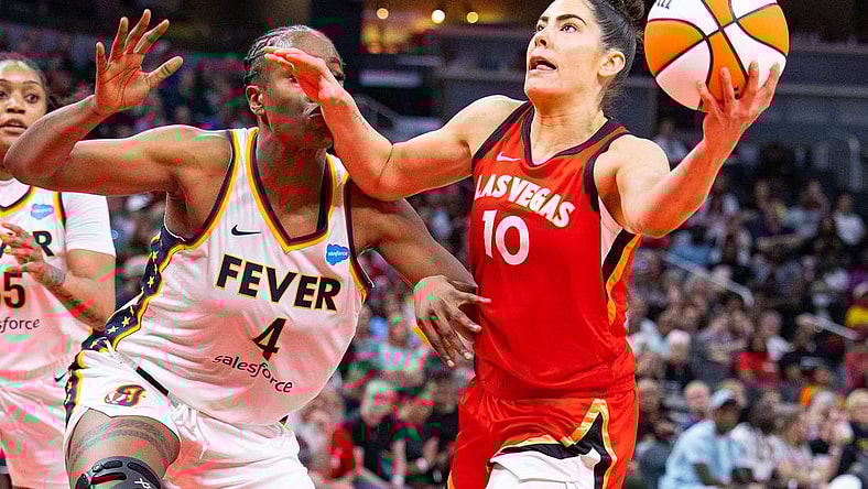 Jun 4, 2023; Indianapolis, Indiana, USA; Las Vegas Aces guard Kelsey Plum (10) shoots the ball while Indiana Fever center Queen Egbo (4) defends in the second half at Gainbridge Fieldhouse. Mandatory Credit: Trevor Ruszkowski-USA TODAY Sports