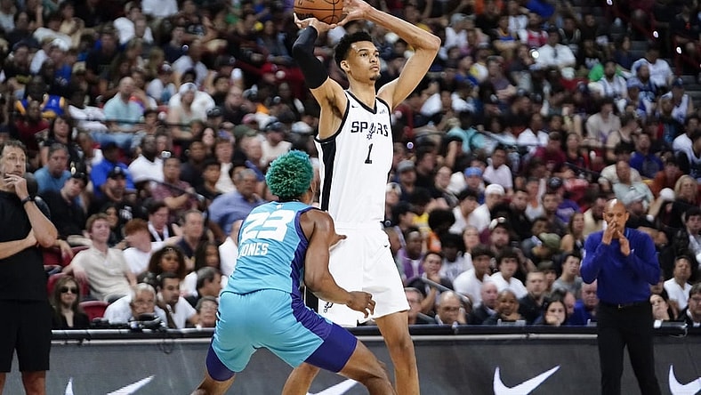 Jul 7, 2023; Las Vegas, NV, USA; San Antonio Spurs forward Victor Wembanyama (1) controls the ball against Charlotte Hornets forward/center Kai Jones (23) during the second half at Thomas & Mack Center. Mandatory Credit: Lucas Peltier-USA TODAY Sports