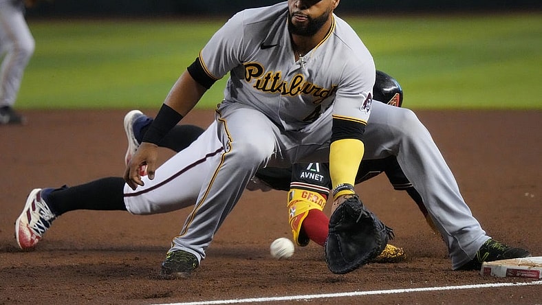 July 9, 2023; Phoenix, AZ, USA; Pittsburgh Pirates' Carlos Santana (41) catches the ball at first base as Arizona Diamondbacks Geraldo Perdomo (2) slides in safely at Chase Field.