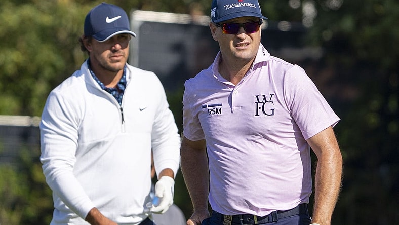 July 17, 2023; Hoylake, ENGLAND, GBR; Brooks Koepka (left) and Zach Johnson (right) watch a tee shot on the fifth hole during a practice round of The Open Championship golf tournament at Royal Liverpool. Mandatory Credit: Kyle Terada-USA TODAY Sports