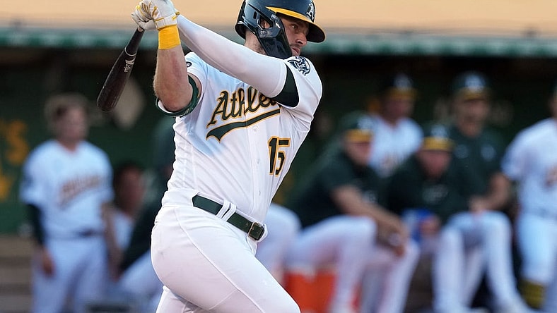 Aug 5, 2023; Oakland, California, USA; Oakland Athletics right fielder Seth Brown (15) hits an RBI single against the San Francisco Giants during the eighth inning at Oakland-Alameda County Coliseum. Mandatory Credit: Darren Yamashita-USA TODAY Sports