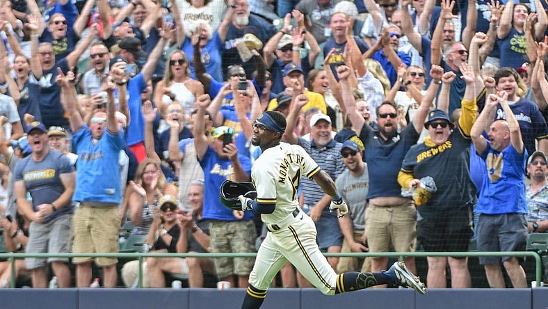 Aug 9, 2023; Milwaukee, Wisconsin, USA; Milwaukee Brewers third baseman Andruw Monasterio (14) and fans celebrate after beating the Colorado Rockies at American Family Field. Mandatory Credit: Benny Sieu-USA TODAY Sports
