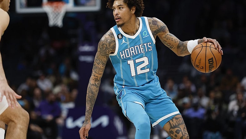 Mar 20, 2023; Charlotte, North Carolina, USA; Charlotte Hornets guard Kelly Oubre Jr. (12) runs the offense against the Indiana Pacers during the second half at Spectrum Center. Mandatory Credit: Nell Redmond-USA TODAY Sports