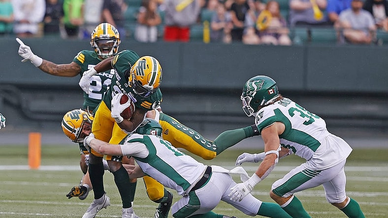 Jun 11, 2023; Edmonton, Alberta, CAN; Saskatchewan Roughriders defensive back Jaxon Ford (17) tackles Edmonton Elks running back Kevin Brown (4) during the second half at Commonwealth Stadium. Mandatory Credit: Perry Nelson-USA TODAY Sports