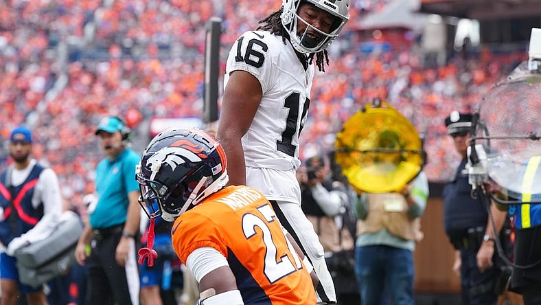 Sep 10, 2023; Denver, Colorado, USA; Las Vegas Raiders wide receiver Jakobi Meyers (16) reacts towards Denver Broncos cornerback Damarri Mathis (27) following his touchdown reception in the first quarter at Empower Field at Mile High. Mandatory Credit: Ron Chenoy-USA TODAY Sports