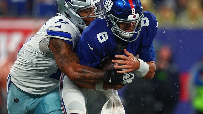 Sep 10, 2023; East Rutherford, New Jersey, USA; New York Giants quarterback Daniel Jones (8) is sacked by Dallas Cowboys linebacker Micah Parsons (11) during the first half at MetLife Stadium. Mandatory Credit: Ed Mulholland-USA TODAY Sports