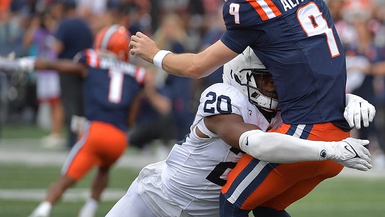 Sep 16, 2023; Champaign, Illinois, USA;  Penn State Nittany Lions defensive end Adisa Isaac (20) tackles Illinois Fighting Illini quarterback Luke Altmyer (9) as he passes the ball during the second half at Memorial Stadium. Mandatory Credit: Ron Johnson-USA TODAY Sports