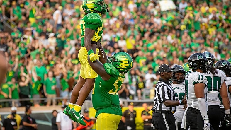 Oregon running back Jordan James is lifted into the air by teammate Marcus Harper II to celebrate a touchdown as the Oregon Ducks host Hawaii Saturday, Sept. 16, 2023, at Hayward Field in Eugene, Ore.