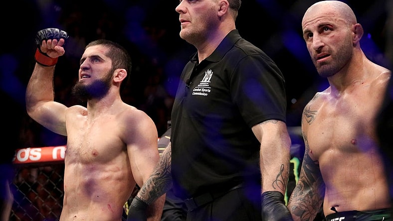 Feb 12, 2023; Perth, WA, AUSTRALIA; Islam Makhachev (red gloves) celebrates after defeating Alexander Volkanovski (blue gloves) for the lightweight championship during UFC 284 at RAC Arena. Mandatory Credit: Jasmin Frank-USA TODAY Sports
