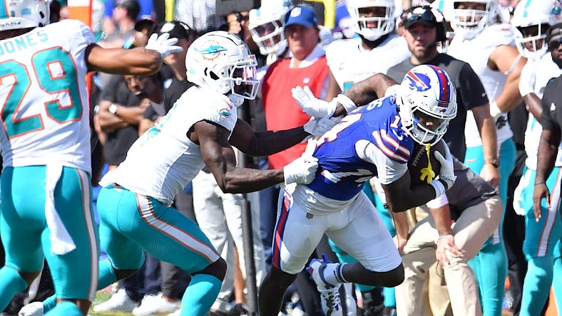 Oct 1, 2023; Orchard Park, New York, USA; Buffalo Bills wide receiver Stefon Diggs (14) breaks a tackle by Miami Dolphins cornerback Kader Kohou (4) to score a touchdown  in the second quarter at Highmark Stadium. Mandatory Credit: Mark Konezny-USA TODAY Sports