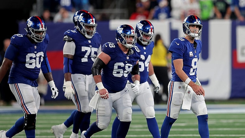 Oct 2, 2023; East Rutherford, New Jersey, USA; New York Giants quarterback Daniel Jones (8) walks off the field with guards Marcus McKethan (60) and Joshua Ezeudu (75) and Ben Bredeson (68) and Mark Glowinski (64) after being sacked during the fourth quarter against the Seattle Seahawks at MetLife Stadium. Mandatory Credit: Brad Penner-USA TODAY Sports