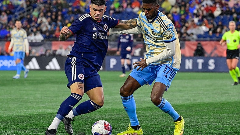 Oct 21, 2023; Foxborough, Massachusetts, USA; New England Revolution forward Gustavo Bou (7) battles Philadelphia Union defender Damion Lowe (17) for the ball during the second half at Gillette Stadium. Mandatory Credit: Eric Canha-USA TODAY Sports