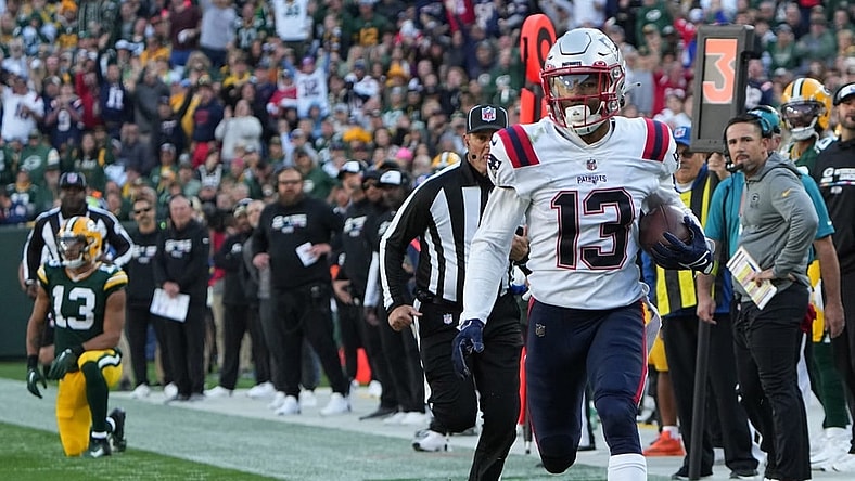 New England Patriots defensive back Jack Jones returns an interception thrown by Green Bay Packers quarterback Aaron Rodgers for a touchdown during the second quarter of their game Sunday, October 2, 2022 at Lambeau Field in Green Bay, Wis.

Packers02 5