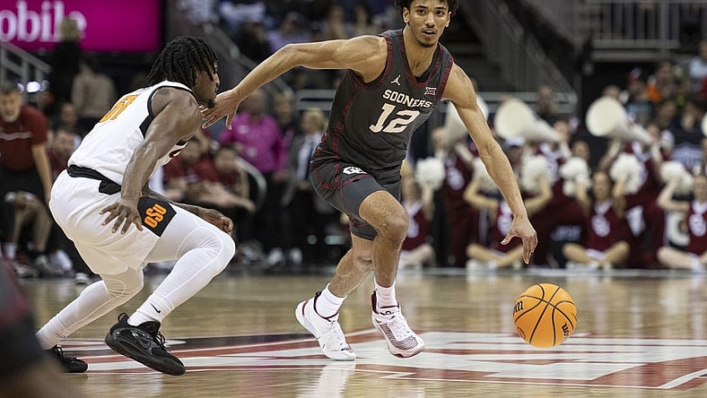 Mar 8, 2023; Kansas City, MO, USA; Oklahoma Sooners guard Milos Uzan (12) dribbles the ball while defended by Oklahoma State Cowboys guard John-Michael Wright (51) in the first half at T-Mobile Center. Mandatory Credit: Amy Kontras-USA TODAY Sports