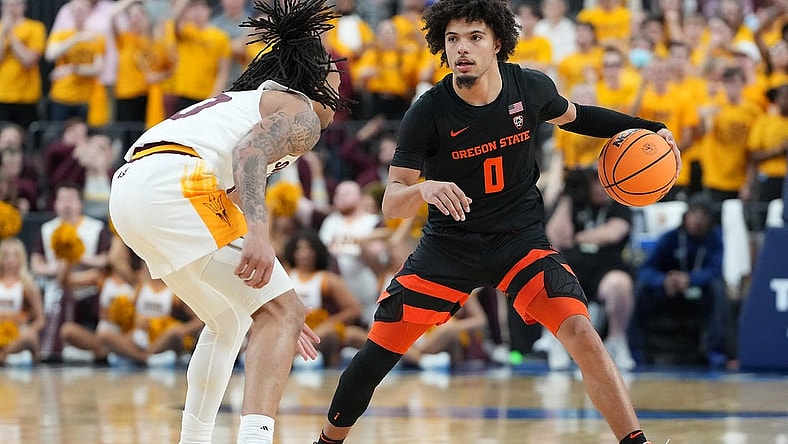 Mar 8, 2023; Las Vegas, NV, USA; Oregon State Beavers guard Jordan Pope (0) dribbles against Arizona State Sun Devils guard Frankie Collins (10) during the second half at T-Mobile Arena. Mandatory Credit: Stephen R. Sylvanie-USA TODAY Sports