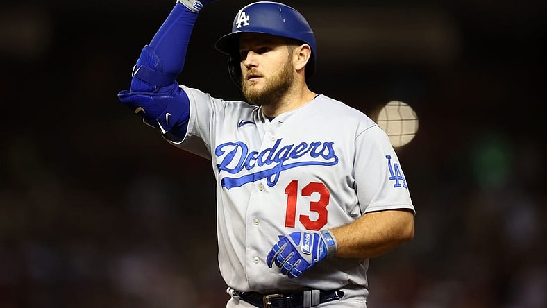 Oct 11, 2023; Phoenix, Arizona, USA; Los Angeles Dodgers third baseman Max Muncy (13) reacts after hitting a single against the Arizona Diamondbacks in the seventh inning for game three of the NLDS for the 2023 MLB playoffs at Chase Field. Mandatory Credit: Mark J. Rebilas-USA TODAY Sports