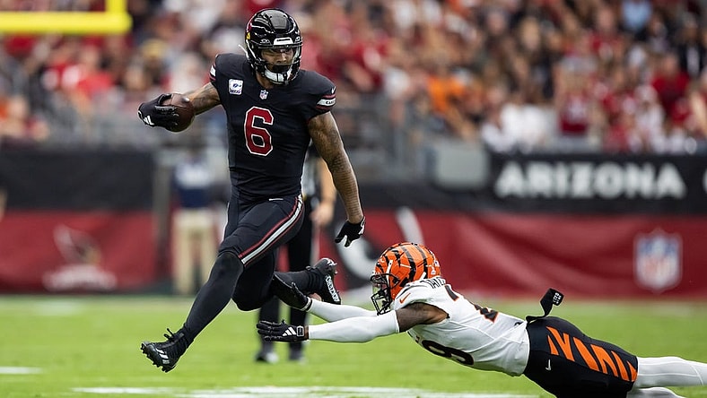 Oct 8, 2023; Glendale, Arizona, USA; Arizona Cardinals running back James Conner (6) against diving Cincinnati Bengals cornerback Cam Taylor-Britt at State Farm Stadium. Mandatory Credit: Mark J. Rebilas-USA TODAY Sports